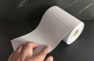Unrolling some fast-tape, prepping to cut out a t-tape
