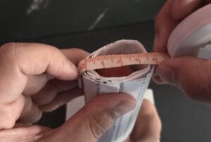 Putting a roll of paper on your erect penis to measure the opening diameter