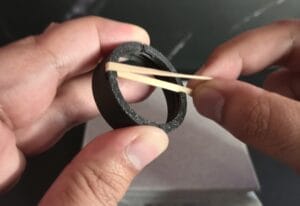 Putting a small rubberband into topper lid