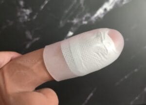 T-Tape Wet Guard rolled over an erect penis with t-tape on. 